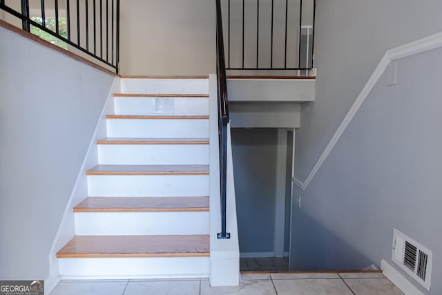 staircase featuring tile patterned floors