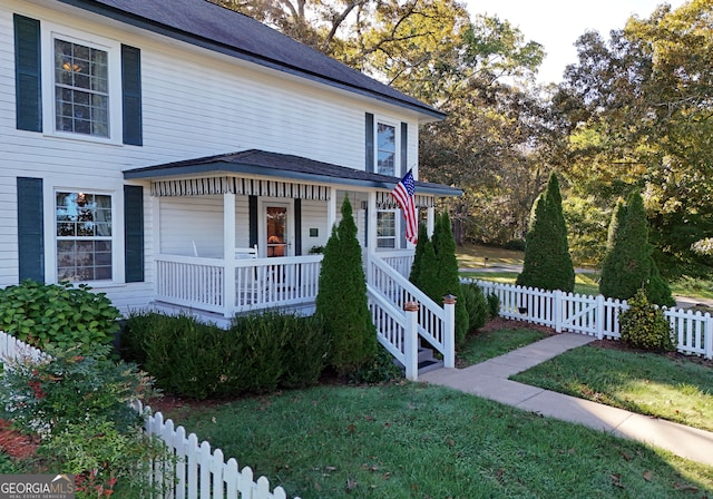 view of front facade with a front yard and a porch