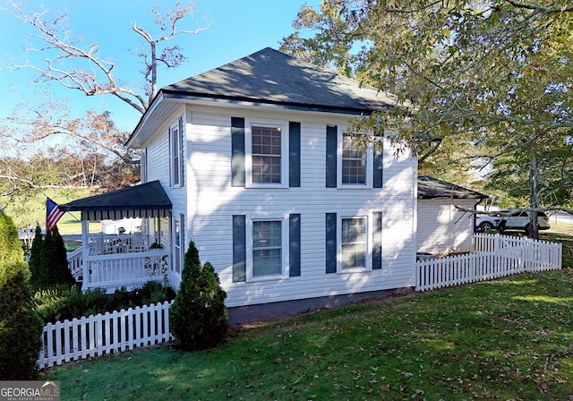 view of side of property with a lawn