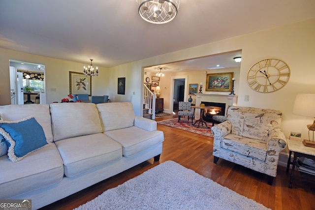 living room with dark wood-type flooring and a chandelier