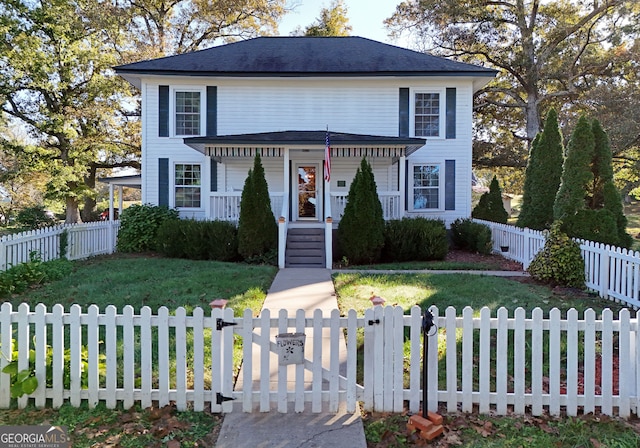 view of front of house with a front yard and covered porch