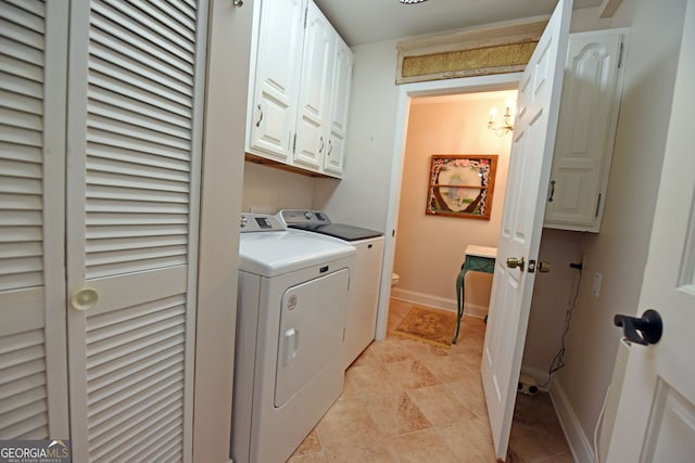 clothes washing area featuring a notable chandelier, independent washer and dryer, and cabinets