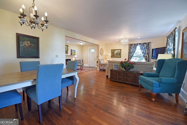 dining area featuring a notable chandelier and dark hardwood / wood-style flooring