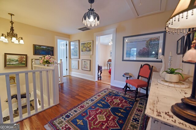 interior space with a chandelier and wood-type flooring