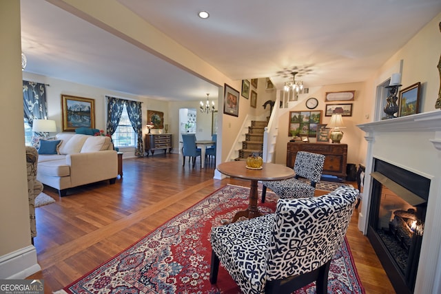 living room with an inviting chandelier and dark hardwood / wood-style floors