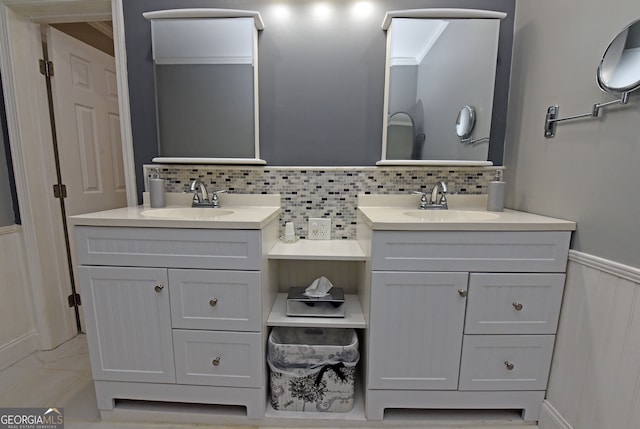 bathroom with vanity and tasteful backsplash