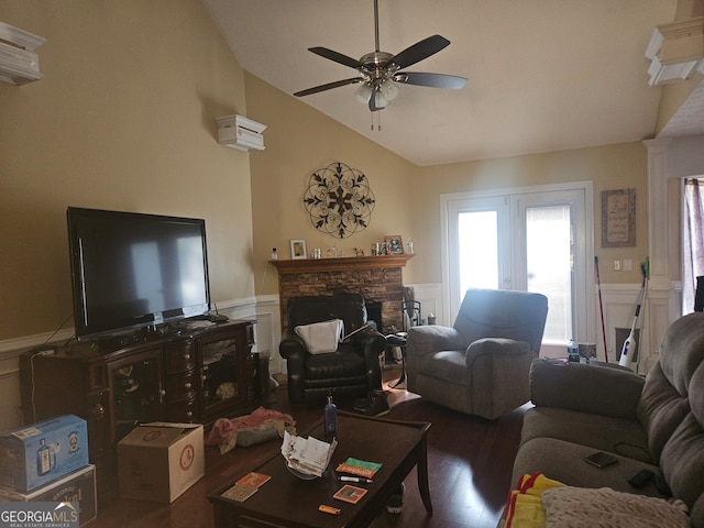 living room with french doors, a stone fireplace, ceiling fan, vaulted ceiling, and dark hardwood / wood-style floors