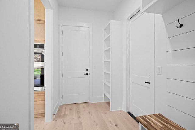 hallway with light hardwood / wood-style flooring