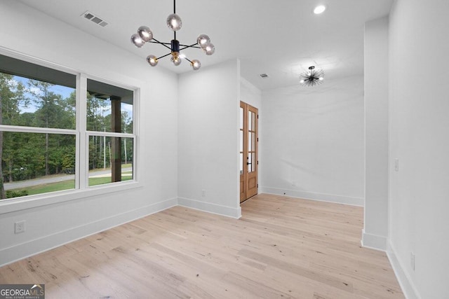 interior space featuring a notable chandelier and light wood-type flooring