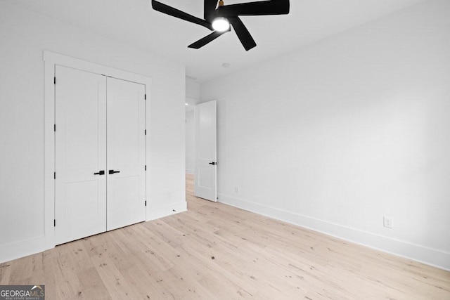 unfurnished bedroom with light hardwood / wood-style flooring, a closet, and ceiling fan