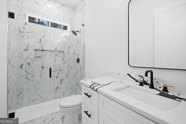 bathroom featuring vanity, a shower with shower door, and toilet