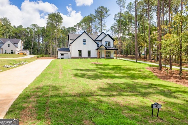 view of front of property with a front yard and a garage