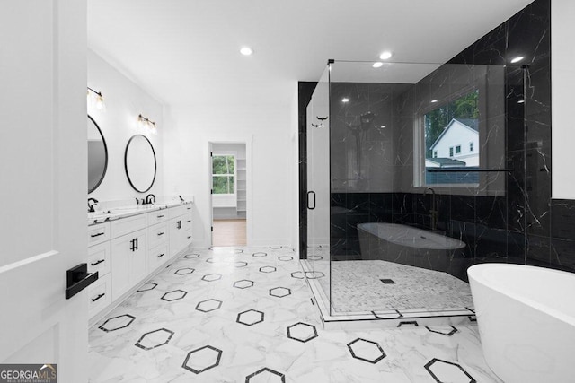 bathroom with vanity, tile walls, and shower with separate bathtub