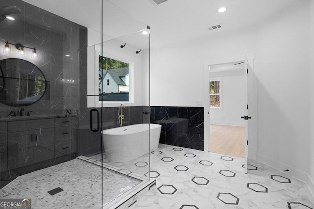 bathroom with vanity, plus walk in shower, and plenty of natural light