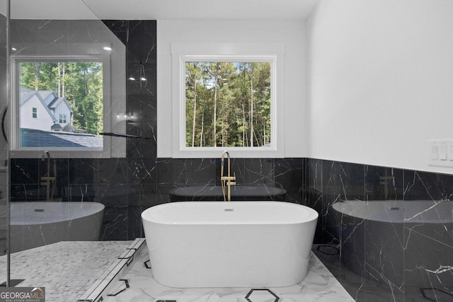 bathroom with plus walk in shower and tile walls