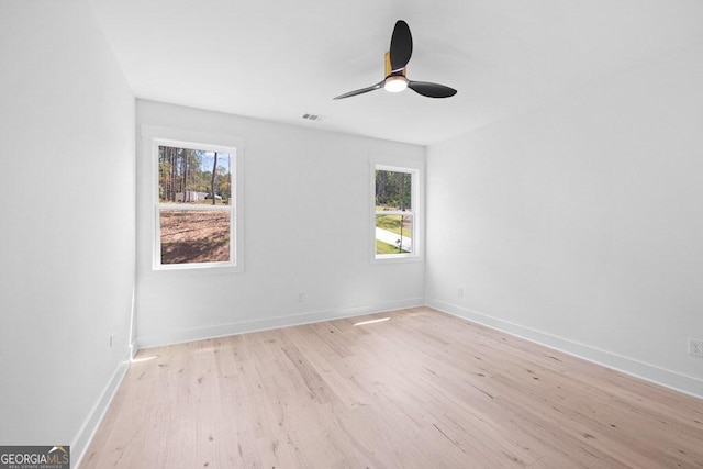 spare room with ceiling fan and light hardwood / wood-style flooring