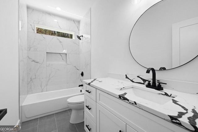 full bathroom with vanity, tiled shower / bath combo, toilet, and tile patterned flooring