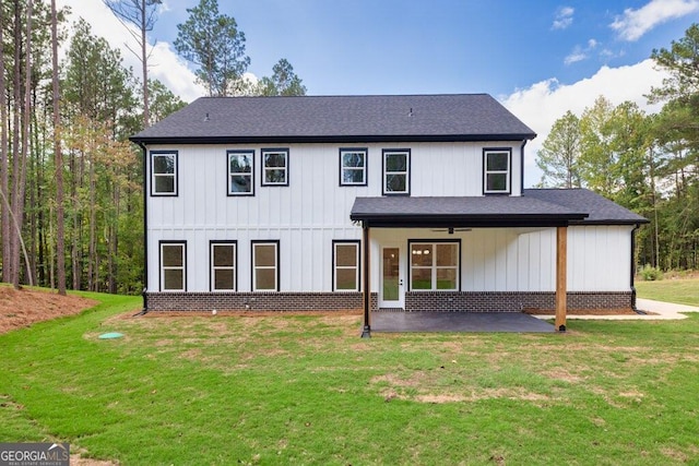 rear view of property featuring a patio, a lawn, and ceiling fan