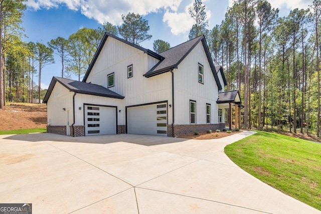 view of side of home with a lawn and a garage