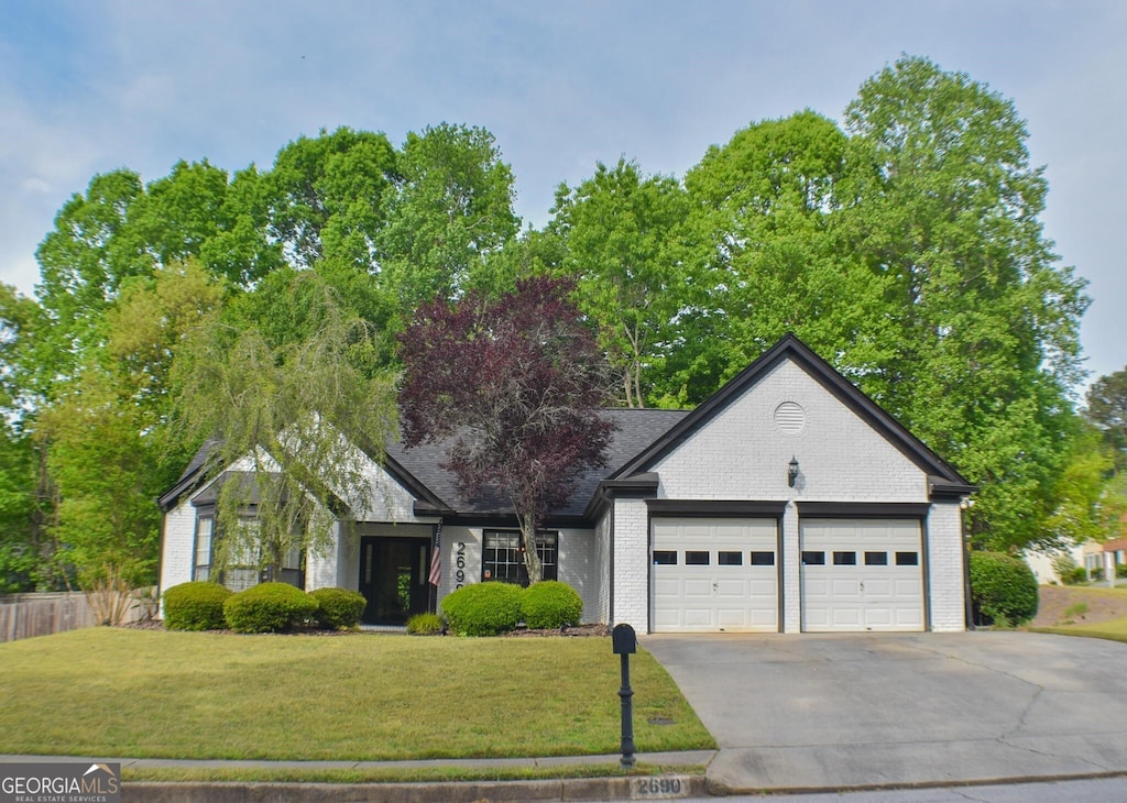 view of front facade with a garage and a front lawn