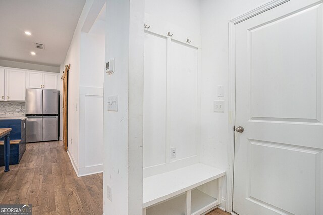 mudroom with light hardwood / wood-style flooring