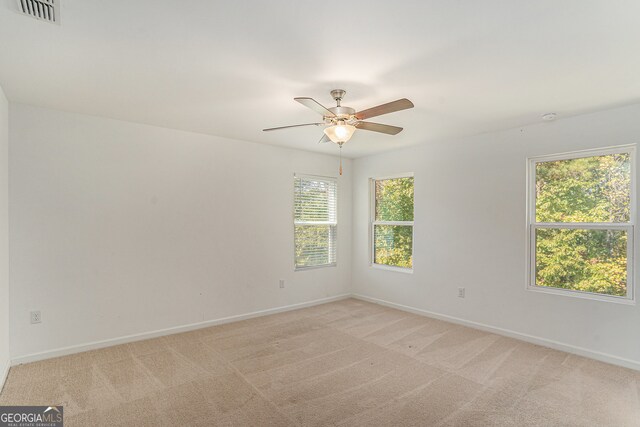 carpeted empty room with ceiling fan