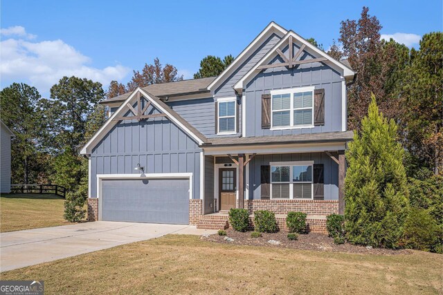 craftsman-style home with a front yard, covered porch, and a garage