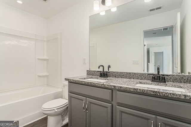 full bathroom featuring vanity, toilet, tub / shower combination, and hardwood / wood-style floors