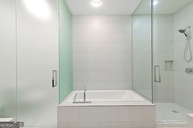 bathroom featuring tile patterned floors and plus walk in shower