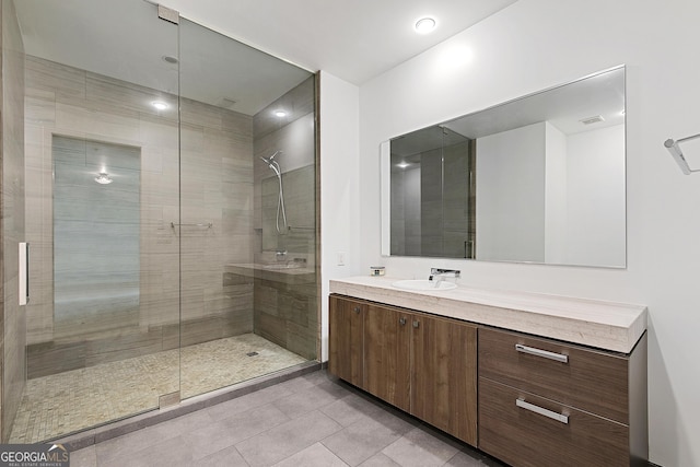 full bathroom featuring tile patterned floors, visible vents, a stall shower, and vanity
