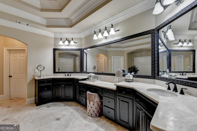 carpeted bedroom with crown molding, ceiling fan, and a raised ceiling