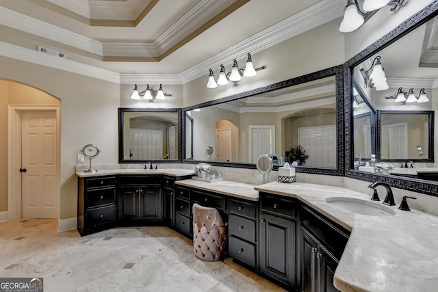 bathroom featuring vanity, crown molding, and a raised ceiling