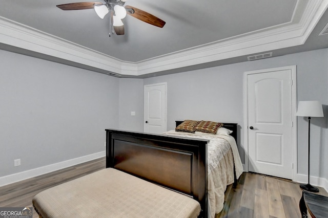 bedroom featuring ornamental molding, hardwood / wood-style floors, and ceiling fan