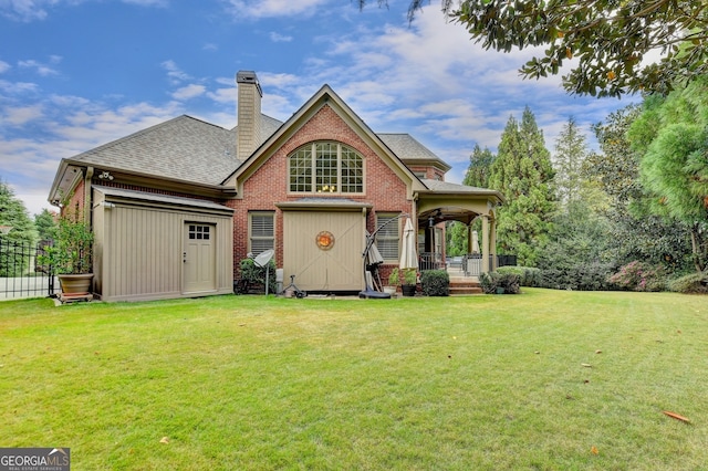 rear view of house featuring a lawn