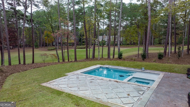 view of pool with an in ground hot tub and a lawn