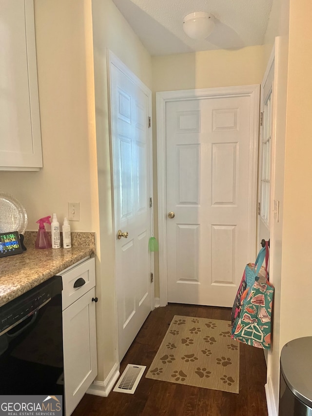 entryway featuring a textured ceiling and dark hardwood / wood-style flooring