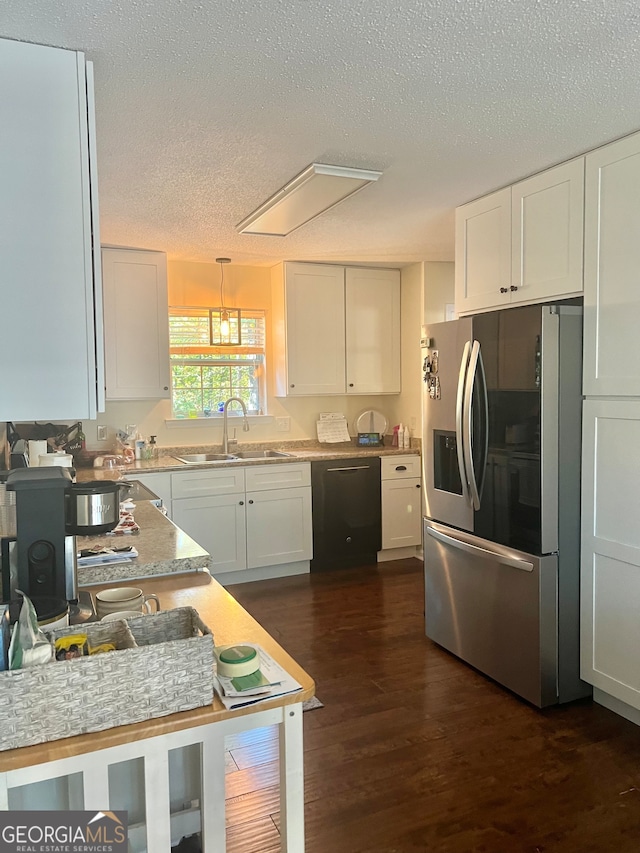 kitchen with dishwasher, stainless steel refrigerator with ice dispenser, hanging light fixtures, sink, and white cabinetry