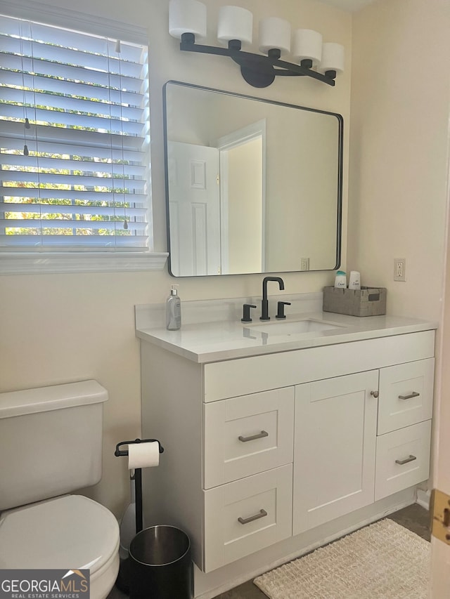 bathroom with vanity and toilet