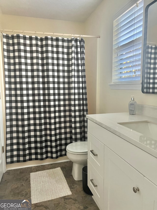 bathroom with vanity, a textured ceiling, a shower with curtain, and toilet