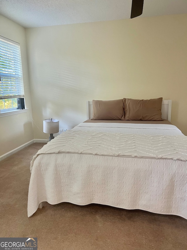 bedroom with carpet and a textured ceiling