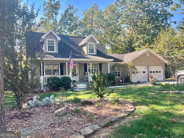 cape cod house with covered porch, a garage, and a front lawn