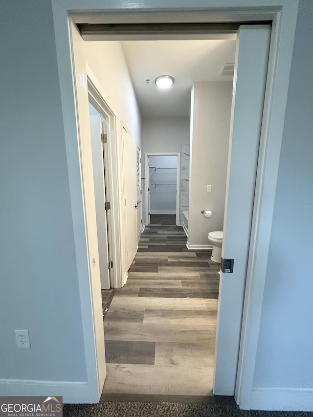 corridor with dark hardwood / wood-style floors