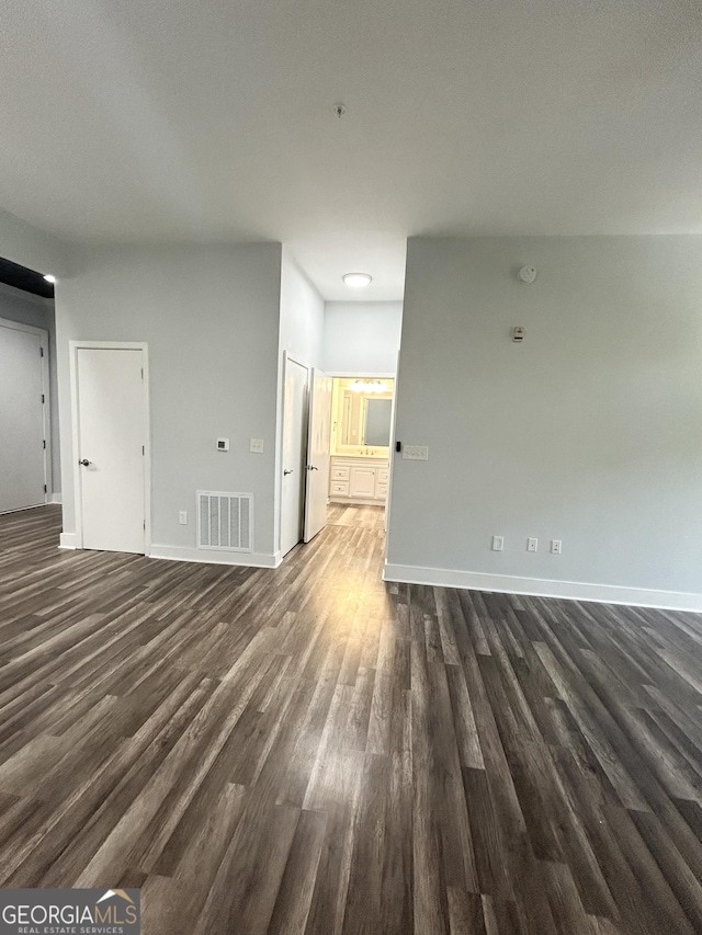 unfurnished living room with dark hardwood / wood-style floors