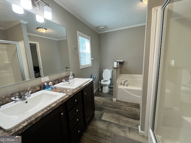 full bathroom with vanity, ornamental molding, hardwood / wood-style flooring, and separate shower and tub