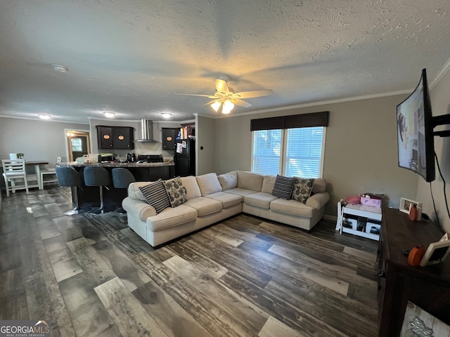 living room featuring ceiling fan, crown molding, a textured ceiling, and dark hardwood / wood-style flooring