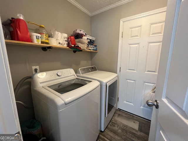 laundry area with ornamental molding, washer and dryer, a textured ceiling, and dark hardwood / wood-style floors