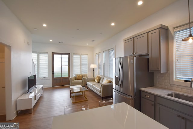 kitchen with gray cabinets, decorative backsplash, dark hardwood / wood-style floors, and sink