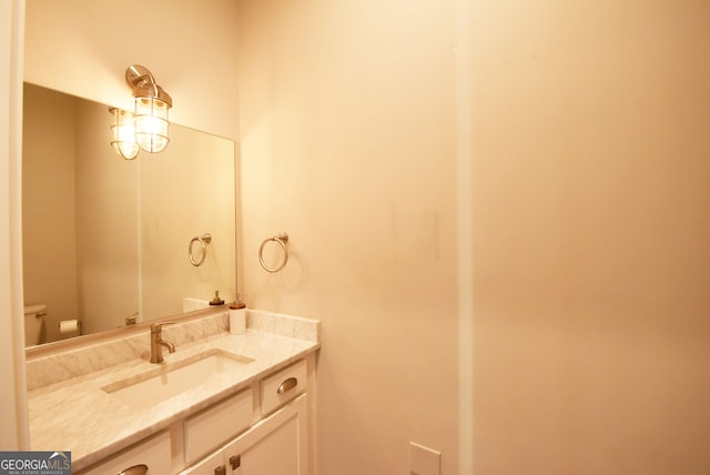 bathroom with toilet and vanity