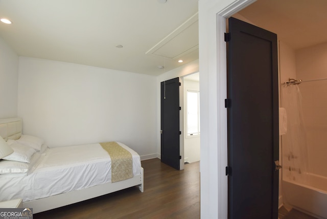 bedroom with dark hardwood / wood-style floors