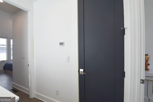 hallway with dark hardwood / wood-style floors